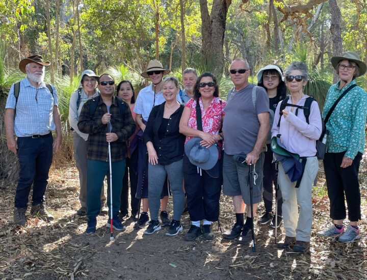 Friends of Retina Australia group and volunteer guides standing together in the bush during their walk